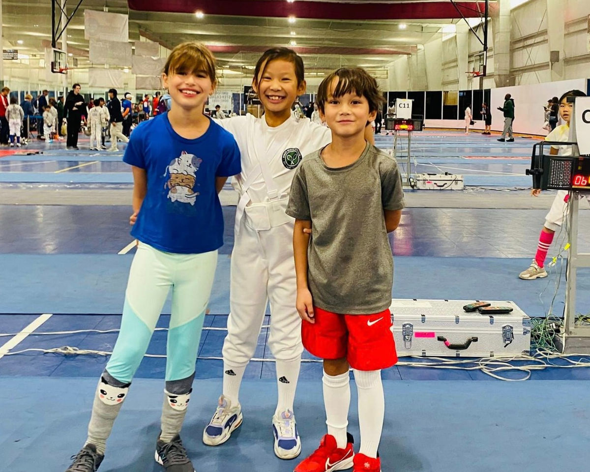 Young NJFA fencers smiling at a tournament